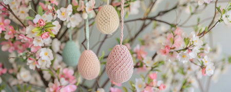 A Serene Easter Morning Scene: Delicate Pastel Macrame Easter Eggs Hanging Amidst Spring Blossomsの素材