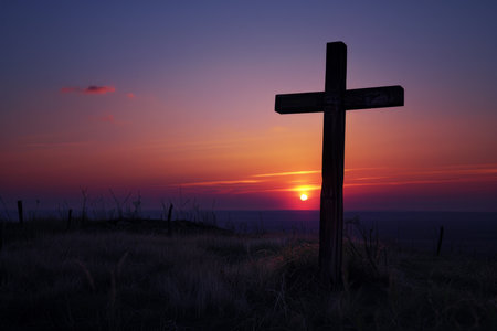Easter Morning Glory: The Warm Glow of Sunrise Embracing a Wooden Crossの素材