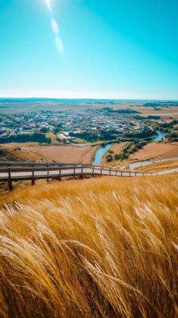 Wooden fence on the meadow with a view of the cityの素材