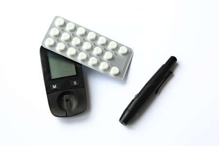 close-up blood sugar measuring machine with pills