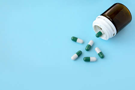 bottle of medicine pills on a blue backgroundの写真素材