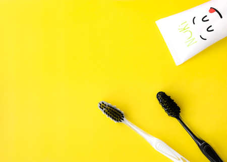 toothbrush and toothpaste on yellow backgroundの写真素材