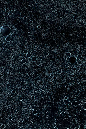 macro drops of blue coloron a black backgroundの写真素材