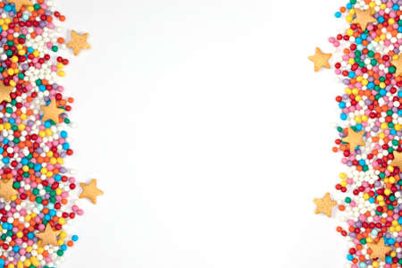 pastry stars and colored balls on the sides on a light backgroundの写真素材