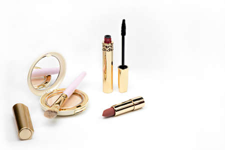 golden color cosmetics on white background