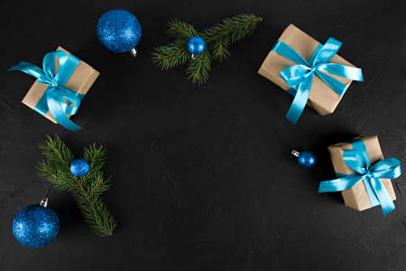christmas background in black with gifts, ornament and fir branchesの写真素材