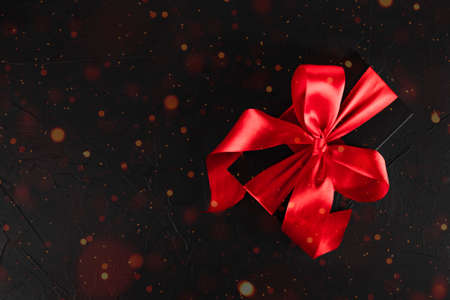 black festive background with black gift with red ribbonの写真素材