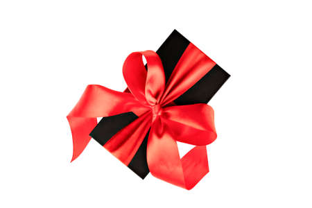 black gift box with red ribbon isolatedの写真素材