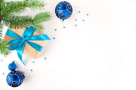 christmas card fir tree branch with blue ornaments and gift with blue ribbonの写真素材