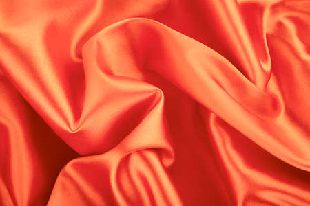 background silk orange fabric close upの写真素材