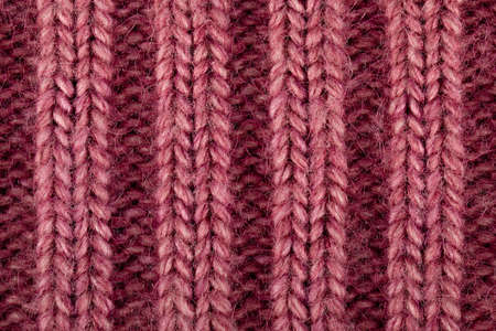 woolen knitted background pink color close up