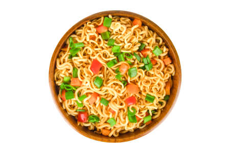 noodles with red pepper and green onion in a wooden bowl isolatedの写真素材