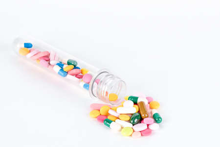 colored medical pills and capsule on gray backgroundの写真素材