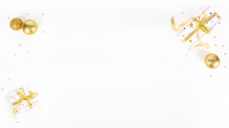 light christmas background with golden ornaments and gifts with golden ribbonの写真素材