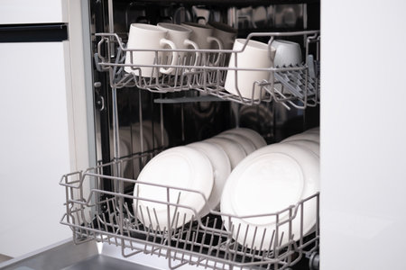 Built-in dishwasher door open. Kitchen with built-in appliances.の写真素材