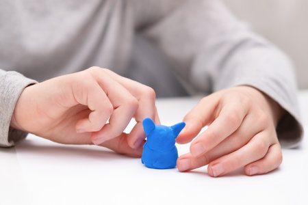 children's hands sculpt from plasticine close up.の写真素材