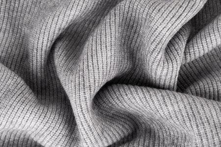 Wool knitwear Gray background Close-up.