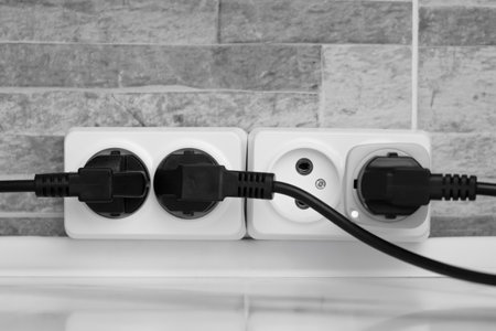 electrical white socket with black plugs.