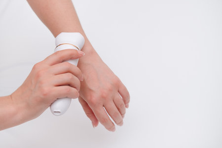 women's hands doing depilation on their hands.の写真素材