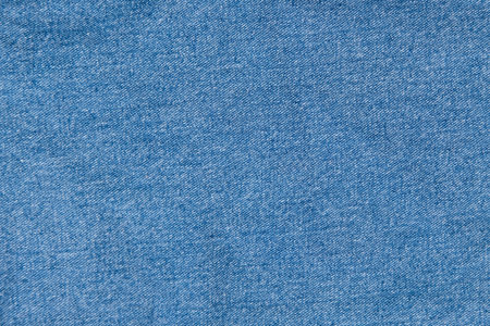 background of blue denim fabric close up.の写真素材