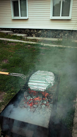 fish in foil is cooked on the grill.の写真素材
