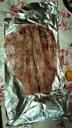 fish in foil is cooked on the grill.の写真素材