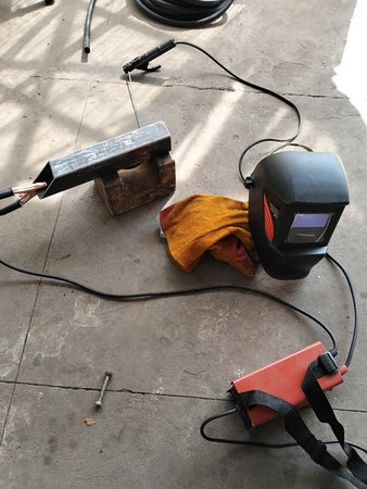 Welding Equipment and Protective Gear on Floor.の写真素材