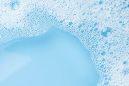 white soapy water on a blue background.の写真素材