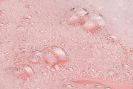 white soapy water on a pink background.の写真素材