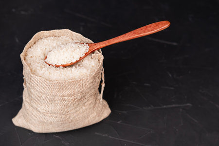 A bag of rice on a black background.の写真素材