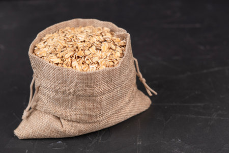 Oatmeal in a bag on a black background.の写真素材