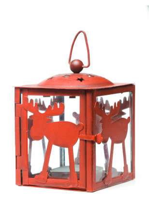 Red metal candle lantern with raindeer decoration on white backgroundの写真素材