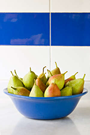 Large group of pears in blue bowlの写真素材