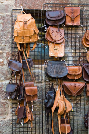 collection of casual leather bags on street market