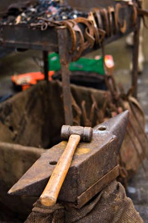 Anvil and hammer  Blacksmith tools outdoor in vertical compositionの写真素材