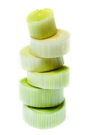 Some pieces of chopped leek stacked on white backgroundの写真素材