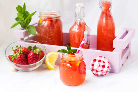 Retro glass jar of detox water with strawberries, lemon and mintの写真素材
