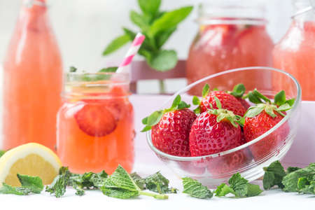 Retro glass jar of detox water with strawberries, lemon and mintの写真素材