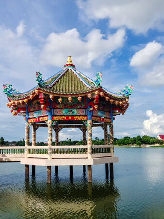 Chinese Temple near the lake on cloudy day portraitの写真素材