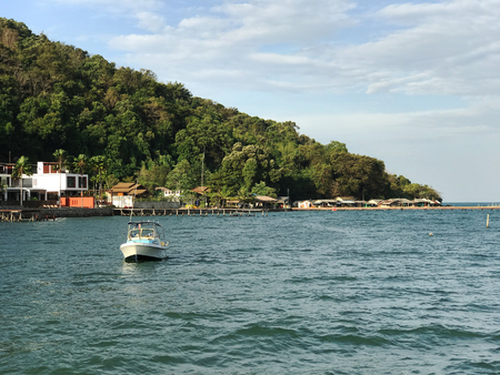 Blue sea with floating boatの写真素材