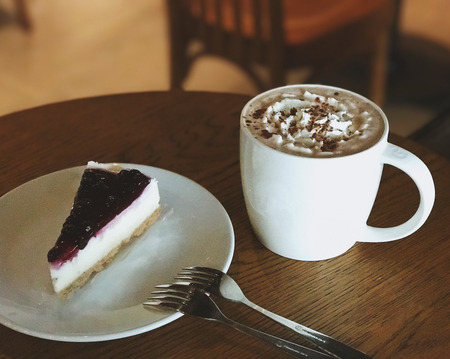 A cup of coffee and blueberry cheese cakeの写真素材