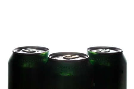 Three green cans of beer. Background for a pub. Beer store. Relax at the weekend. Summer with beer. Low alcohol percentage. Packaging and ecology. White background.の写真素材