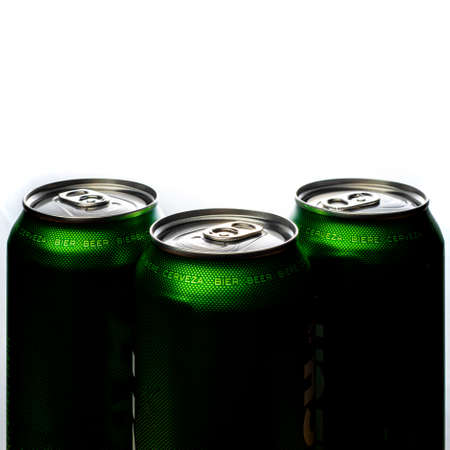 Three green cans of beer. Background for a pub. Beer store. Relax at the weekend. Summer with beer. Low alcohol percentage. Packaging and ecology. White background.の写真素材