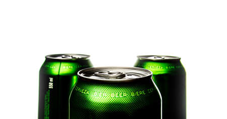 Three green cans of beer. Background for a pub. Beer store. Relax at the weekend. Summer with beer. Low alcohol percentage. Packaging and ecology. White background.の写真素材