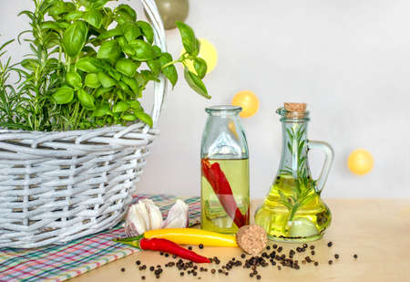 Bottles with flavored oil. Tastes of Italy. Basil, pepper and garlic. Preparing a salad.. Tomatoes...