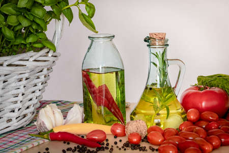 Bottles with flavored oil. Tastes of Italy. Basil, pepper and garlic. Preparing a salad.. Tomatoes and flavors of pizza.の写真素材