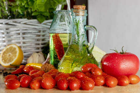 Bottles with flavored oil. Tastes of Italy. Basil, pepper and garlic. Preparing a salad.. Tomatoes and flavors of pizza.の写真素材