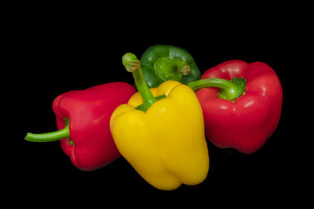 Paprika, red, green and yellow on a black background. Tastes in the kitchen.の写真素材