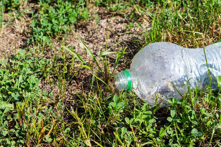 Plastic packaging in the natural environment. Empty used dirty plastic bottles. Environmental pollution. Used plastic waste packaging. Environmental Protection. Take care of nature.の写真素材