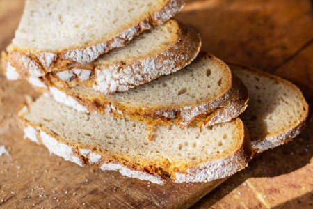 Slices of bread on a wooden board. Preparation of breakfast. Polish cuisine. Straight from the...